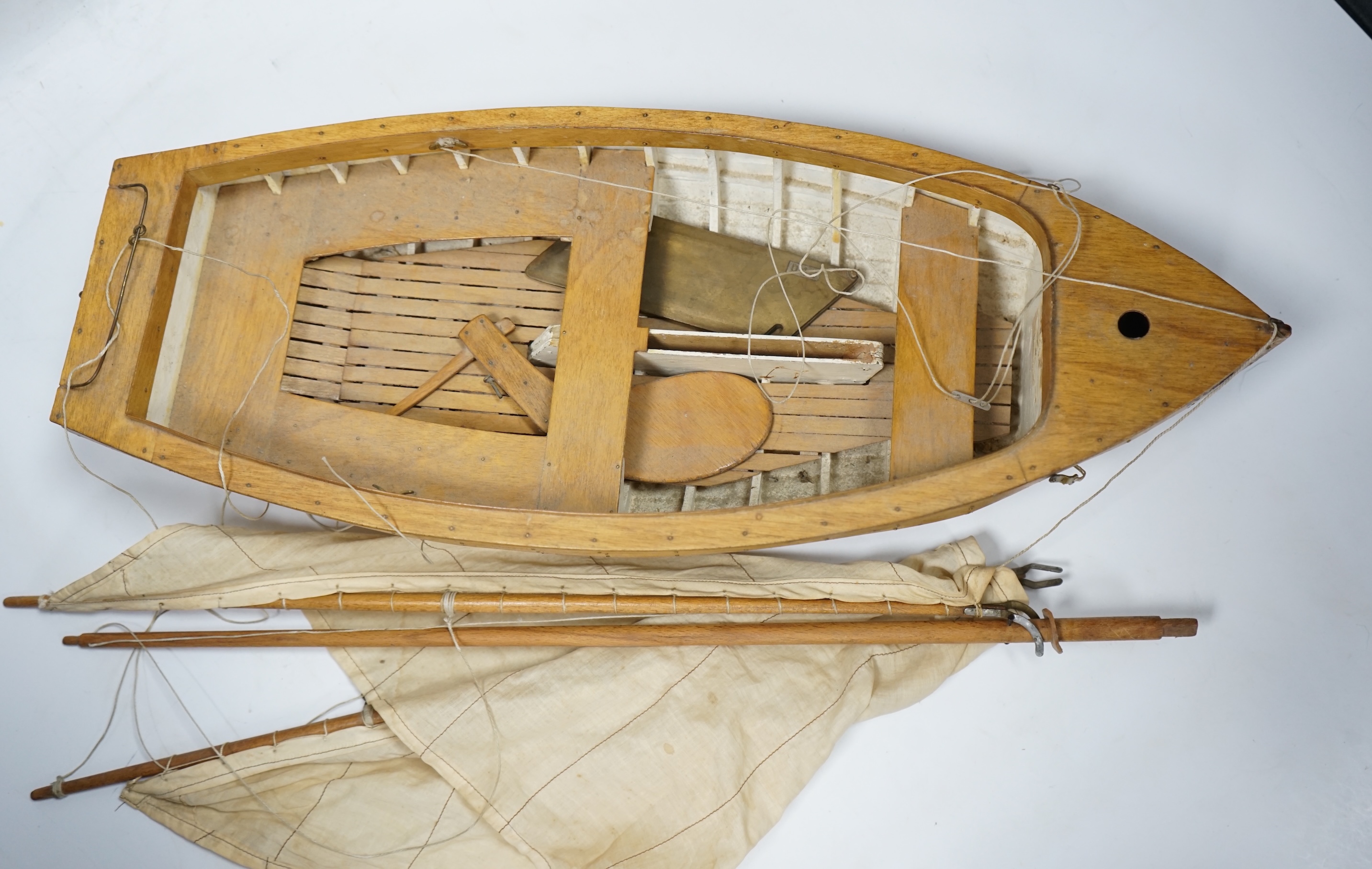 A mid 20th century kit built wooden model sailing boat, ‘Rob’, of plank on frame construction with white painted interior, hull 45cm long. Condition - fair to good.